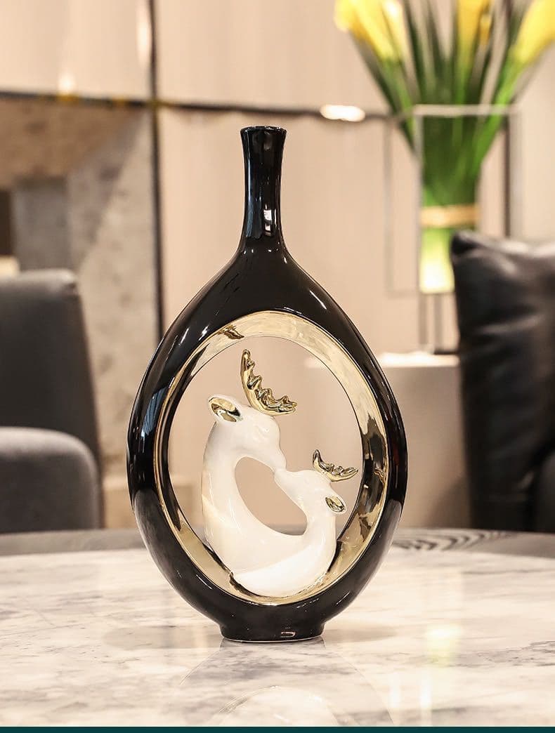 Tall black swan ceramic vase on a marble surface